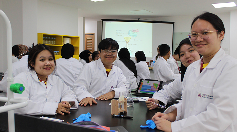 Nursing College Brunei | A group of JCHS students wearing lab coats, studying about chemical elements in the classroom, all ready to nurture their nursing potential.